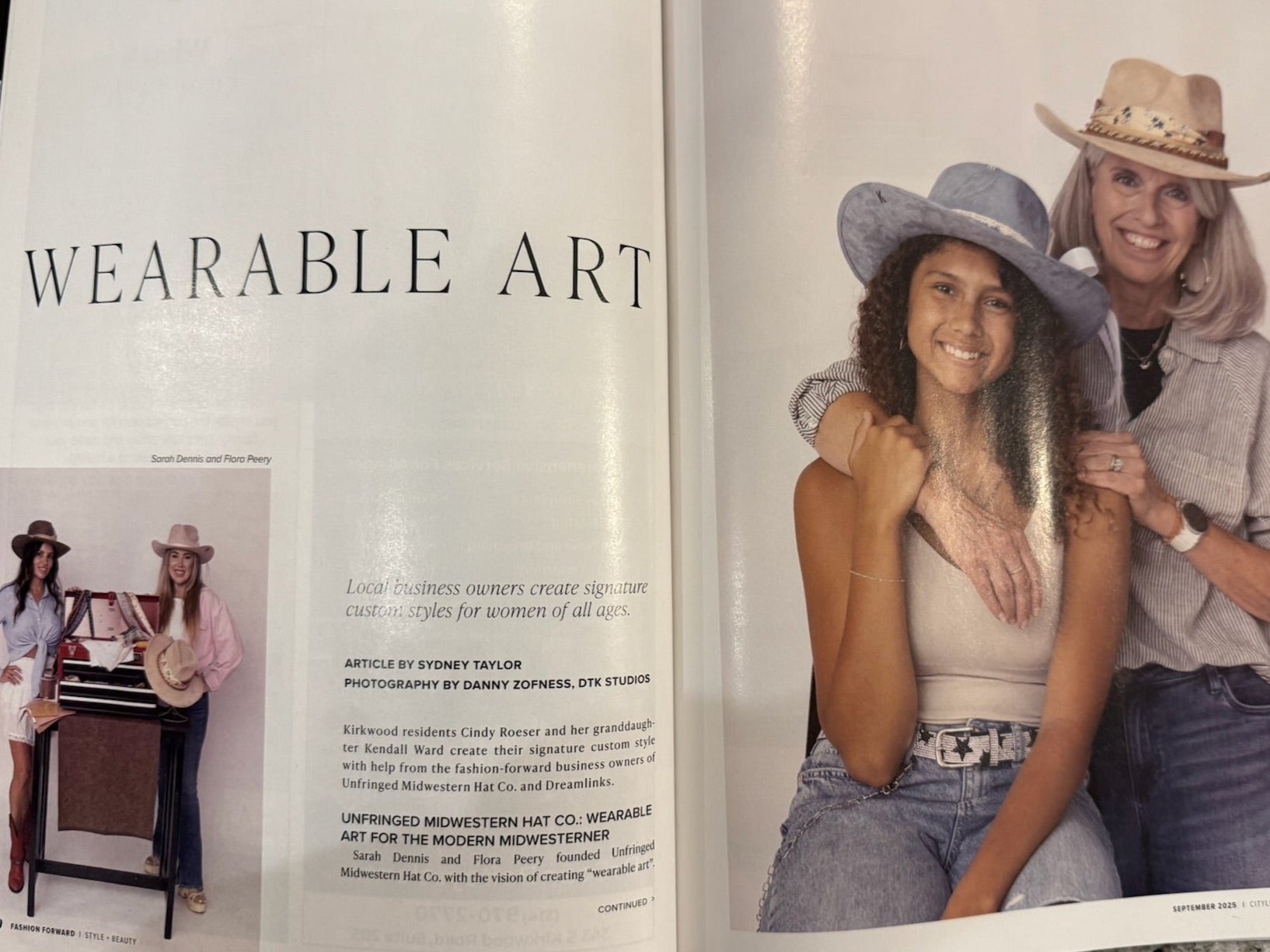 Open book on a surface with images of people and text about 'Wearable Art'.